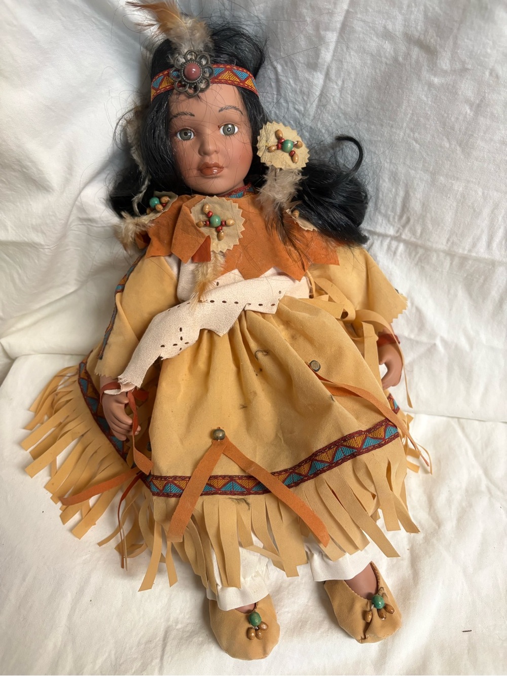 Native American themed porcelain doll,